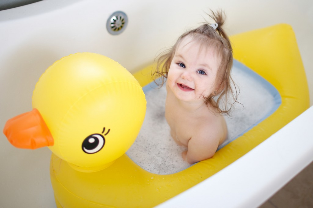 ребенок в детской ванночке в форме утки